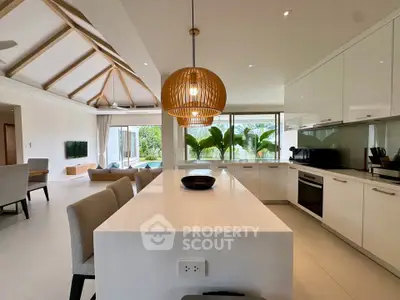 Luxurious open-plan kitchen and living area with modern design and garden view.
