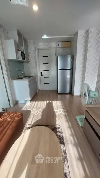 Modern apartment interior with kitchen and living area, featuring stylish decor and natural light.