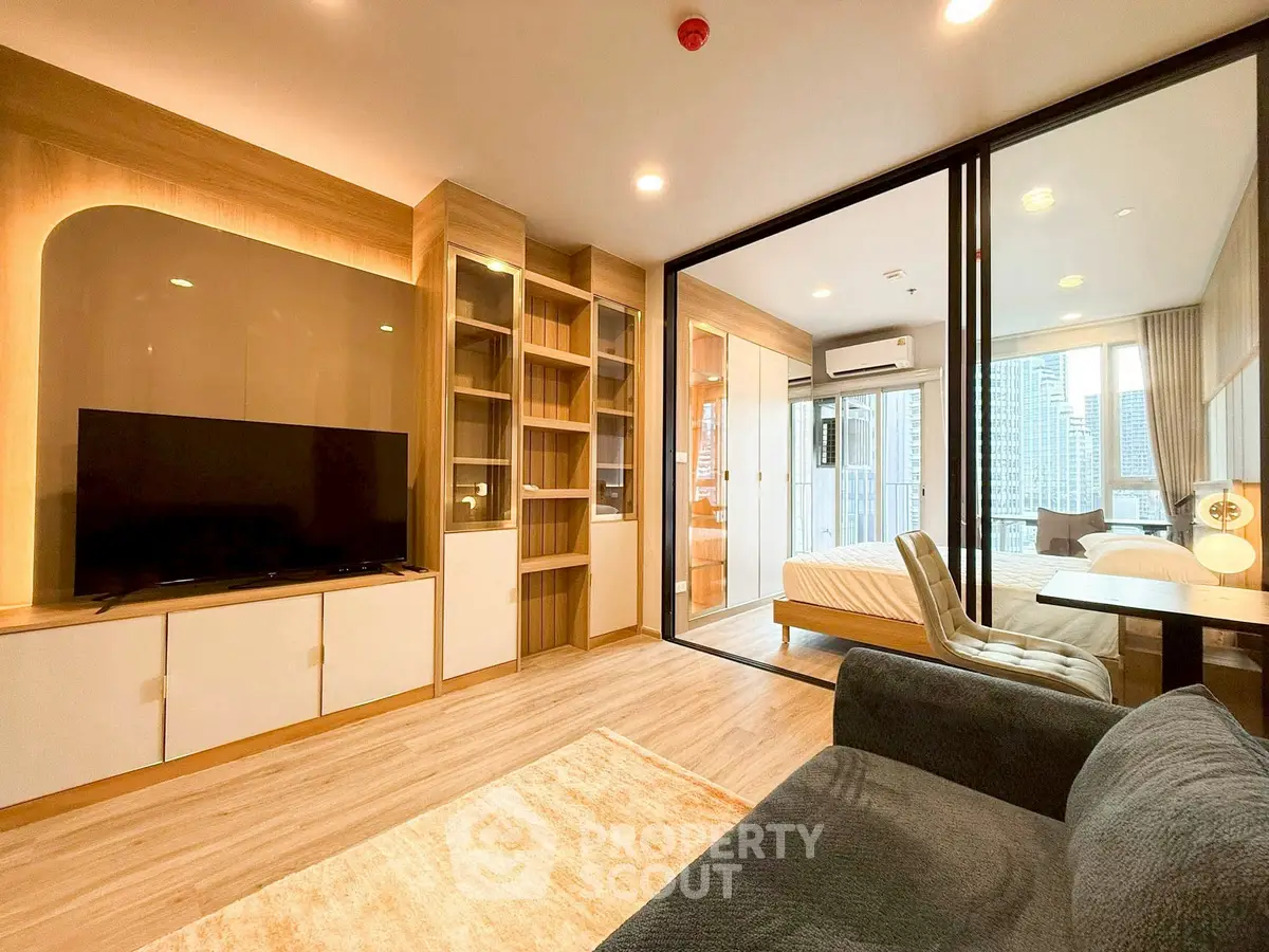 Modern living room with open layout and city view, featuring sleek furniture and wooden accents.