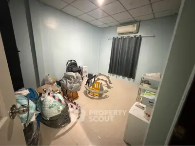 Spacious storage room with air conditioning and tiled floor, ideal for organizing household items.