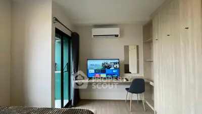 Modern bedroom with TV, air conditioning, and balcony access in stylish apartment.