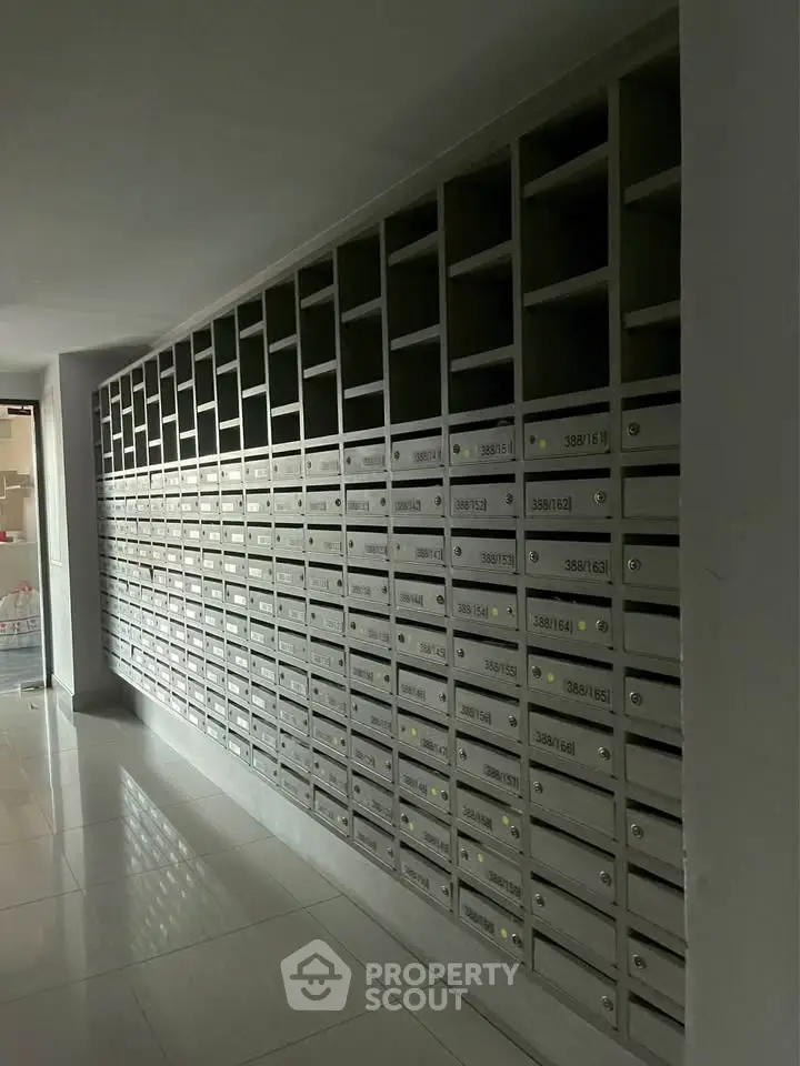 Modern apartment building mailboxes in a sleek hallway, showcasing organized and secure mail storage.