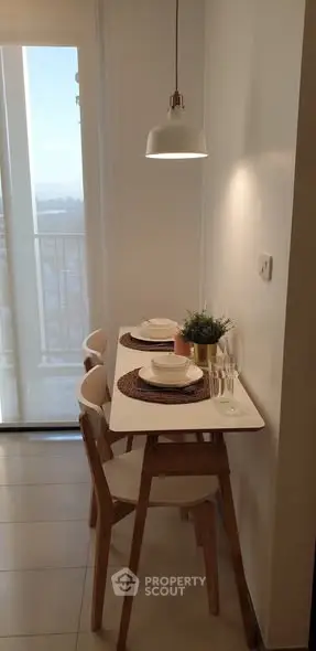 Cozy dining nook with modern decor and natural light in a stylish apartment.