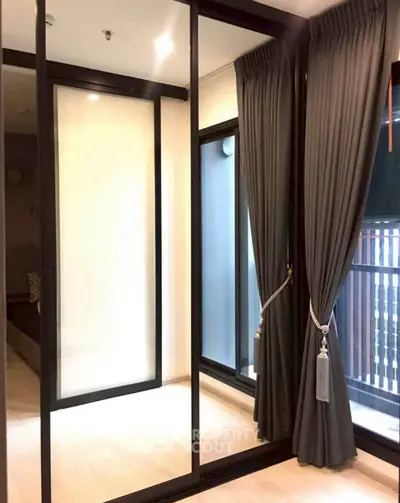 Modern bedroom with floor-to-ceiling windows and elegant curtains, offering a stylish and cozy ambiance.