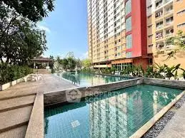 Luxurious condominium with stunning pool and lush garden view