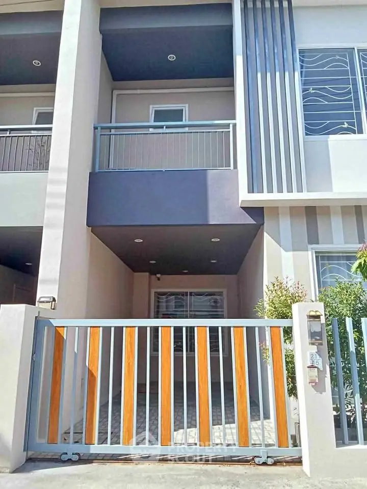 Modern townhouse exterior with stylish facade and gated entrance, perfect for urban living.