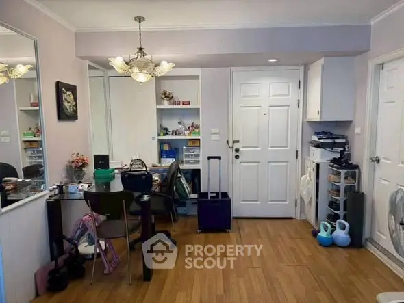 Charming interior space with wooden flooring and elegant lighting, perfect for a cozy home office setup.