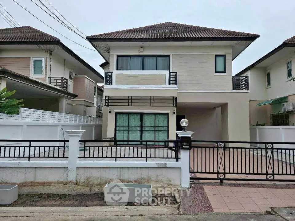 Modern two-story house with spacious driveway and contemporary design in a suburban neighborhood.