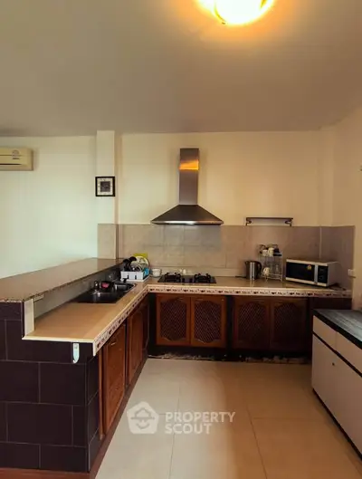 Spacious kitchen with modern gas stove and ample counter space