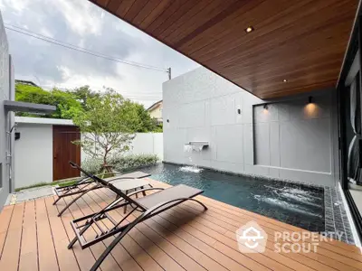 Luxurious modern poolside deck with sleek loungers and serene water feature