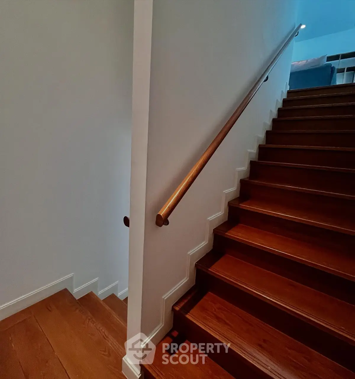 Elegant wooden staircase with sleek handrail in modern home interior