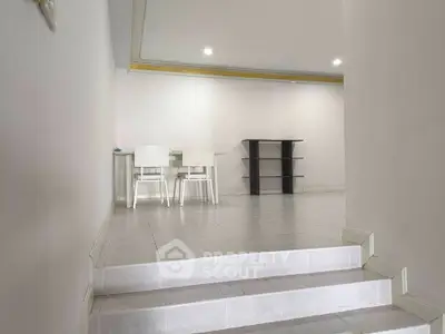Spacious interior with modern dining area and tiled flooring