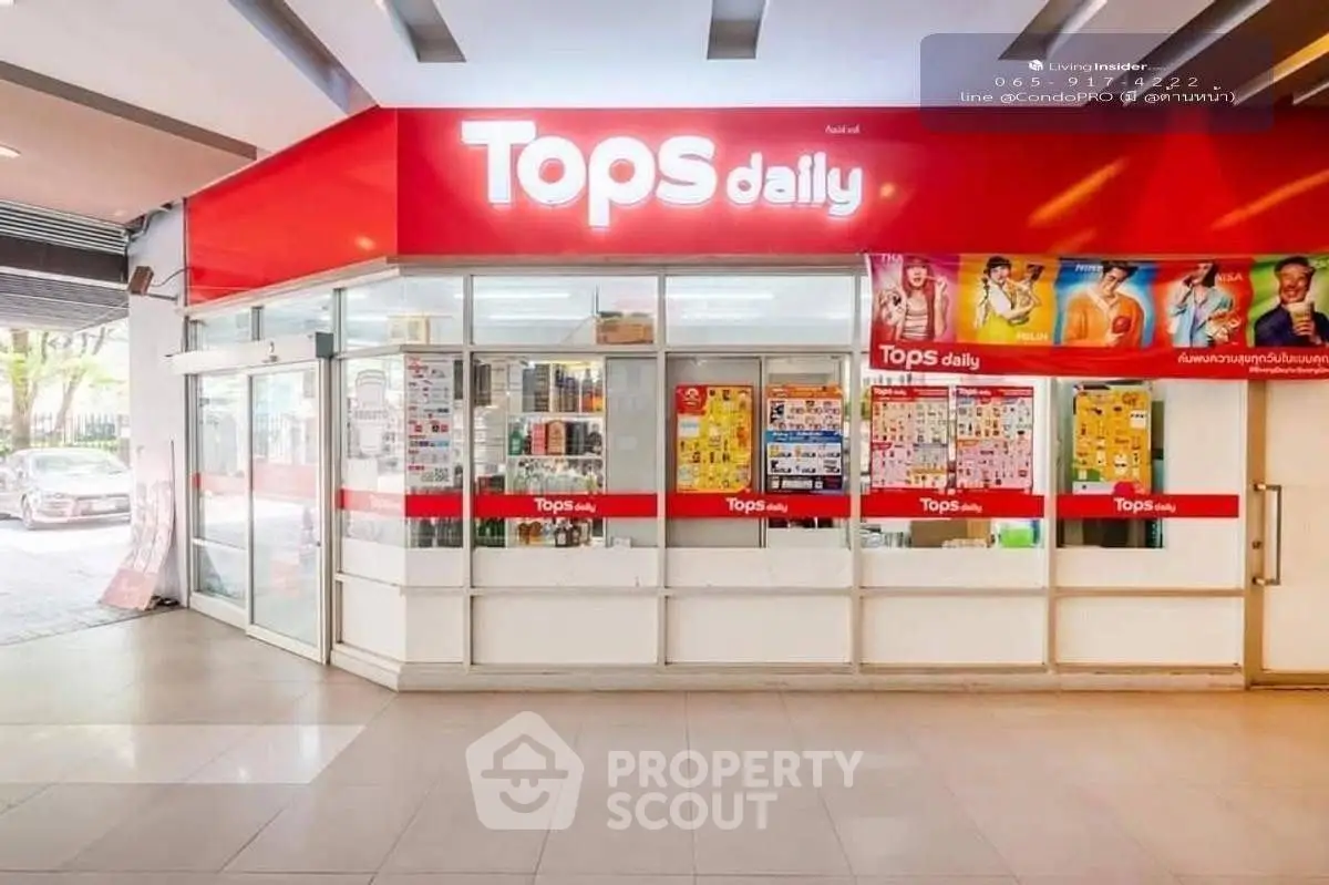 Exterior view of a Tops Daily convenience store with bright signage and promotional posters.