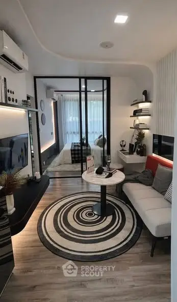 Modern living room with stylish decor and open layout, featuring a cozy seating area and contemporary design.