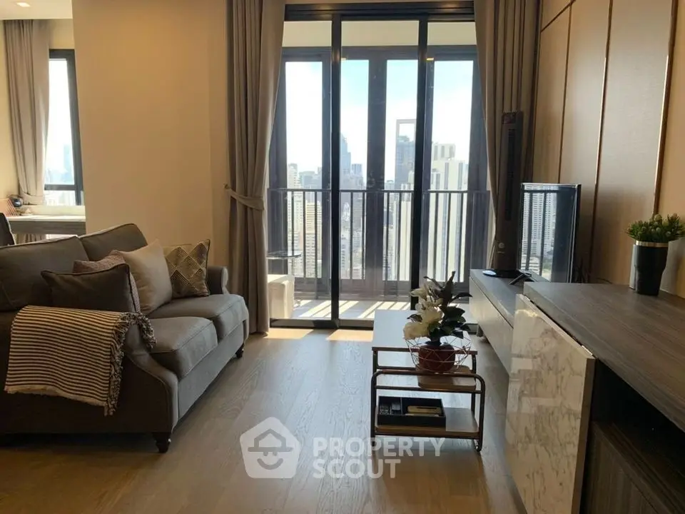 Modern living room with city view, stylish furniture, and natural light.