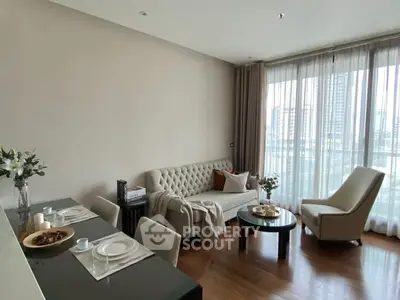 Elegant living room with modern decor and city view, featuring plush seating and dining area.