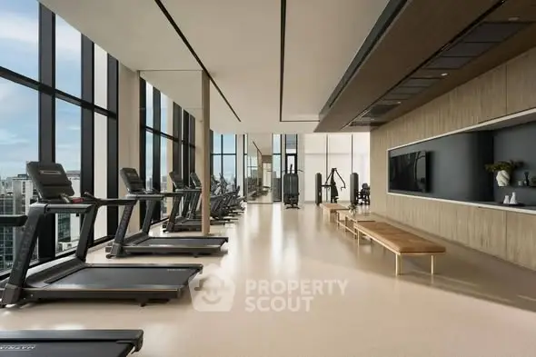 Luxurious high-rise gym with panoramic city views and modern equipment.