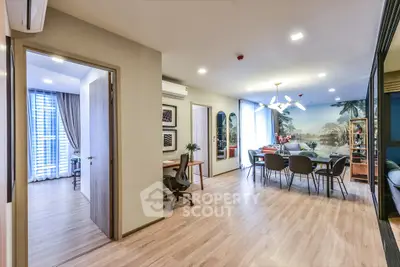 Spacious modern living room with dining area and study nook, featuring elegant decor and natural light.