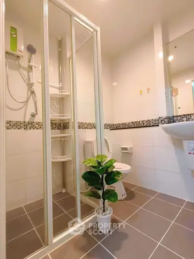 Modern bathroom with glass shower and stylish tile accents