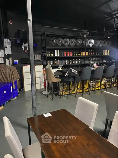 Chic industrial-style bar with modern seating and ambient lighting, perfect for social gatherings.