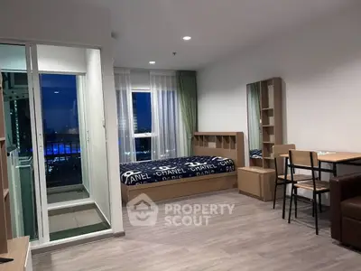 Modern studio apartment with stylish decor and city view, featuring cozy bed and dining area.