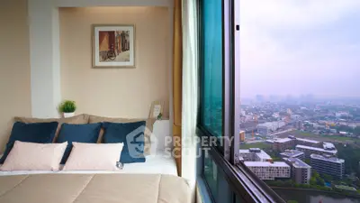 Cozy bedroom with stunning city view from large window, featuring elegant decor and plush bedding.