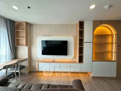 Modern living room with stylish built-in shelves and mounted TV, featuring elegant lighting and cozy seating.