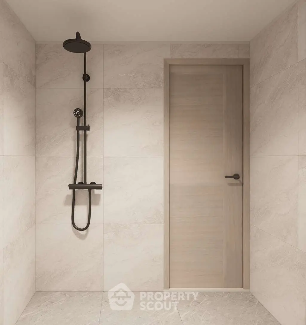 Modern minimalist bathroom with sleek shower design and elegant tile work.