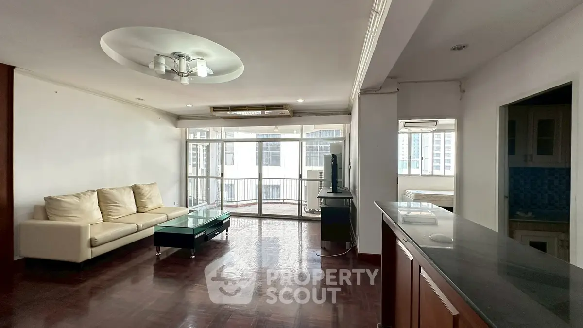 Spacious living room with modern decor and large windows in urban apartment