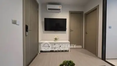 Modern living room with wall-mounted TV and air conditioning unit