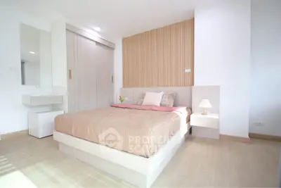 Modern minimalist bedroom with wooden accents and cozy lighting