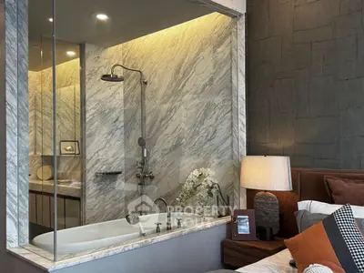 Luxurious bedroom with marble bathroom and modern decor