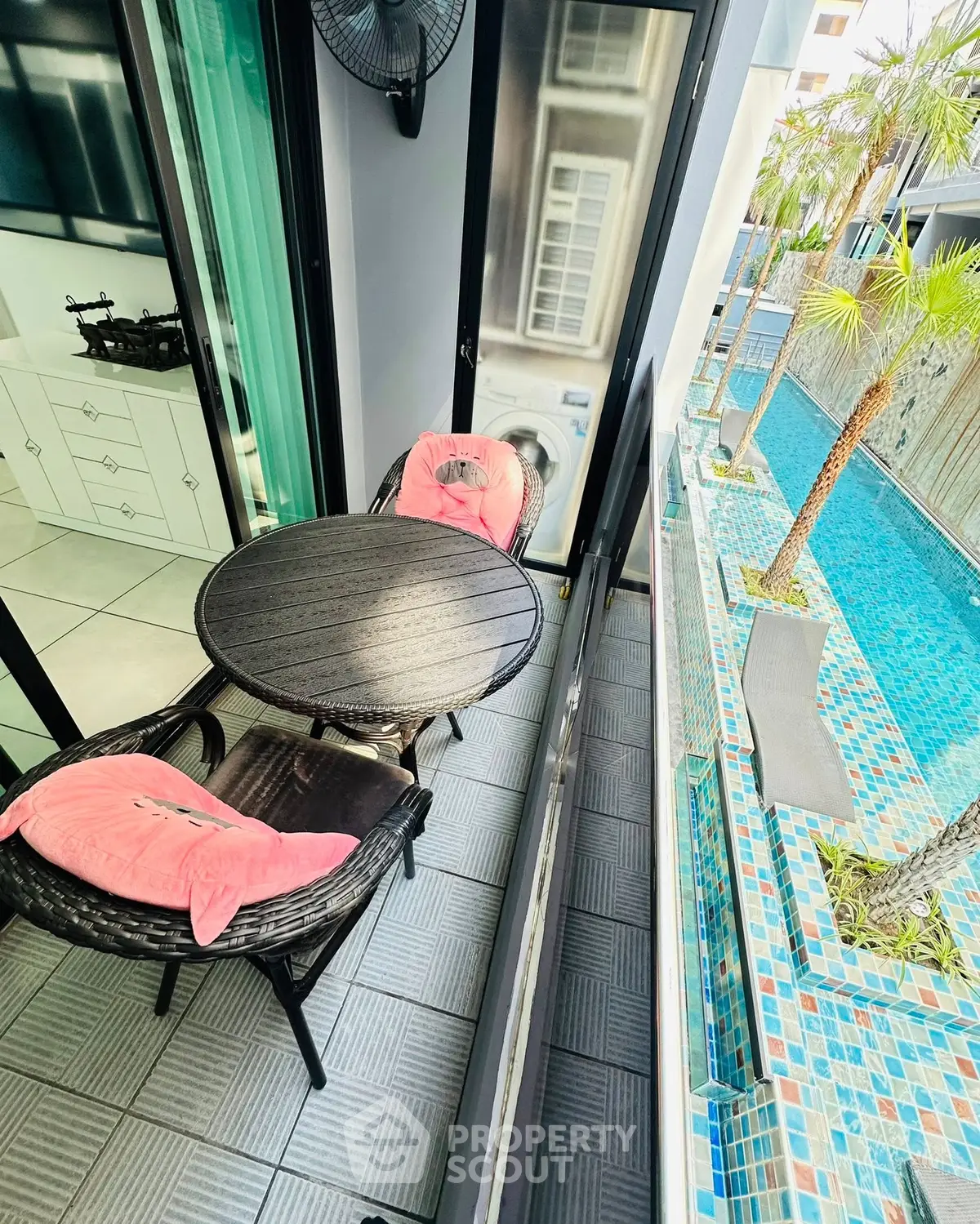 Charming balcony with pool view, perfect for relaxation and leisure in a modern apartment setting.