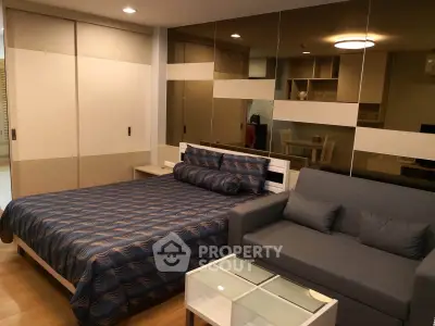 Modern bedroom with stylish decor and comfortable seating area