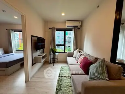 Modern living room with cozy sofa and large window in stylish apartment