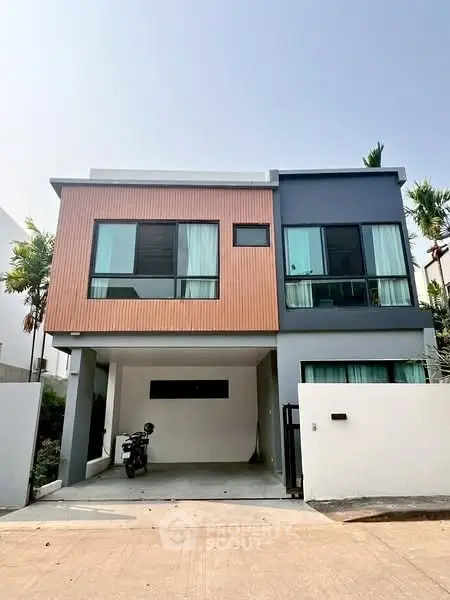 Modern two-story house with sleek design and spacious driveway