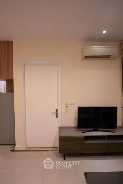 Modern living room with sleek TV stand and air conditioning unit