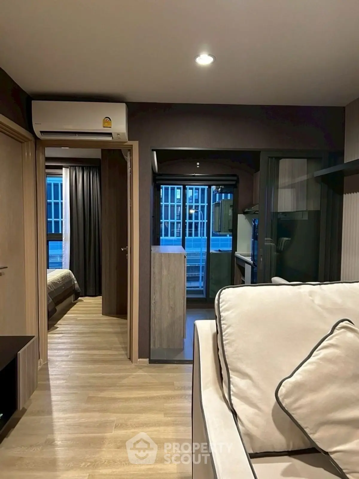 Modern apartment interior with cozy living room and bedroom view