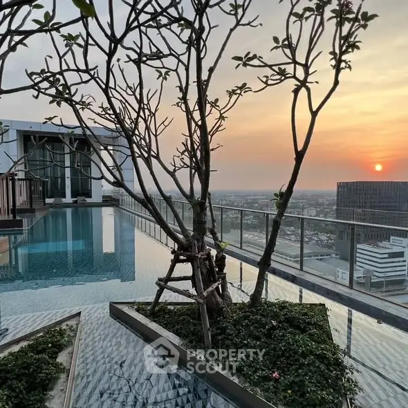 Stunning rooftop pool with panoramic city view at sunset, perfect for relaxation and entertainment.