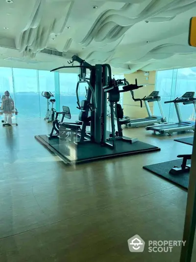 Luxurious high-rise gym with panoramic city views and modern fitness equipment