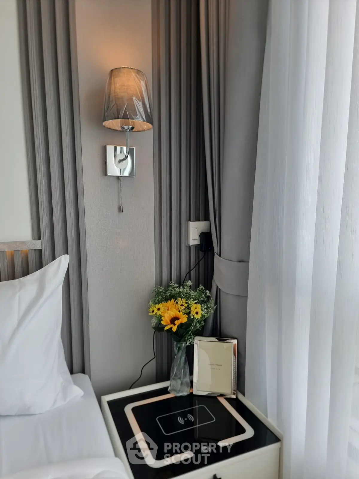 Elegant bedroom corner with stylish lamp and fresh flowers