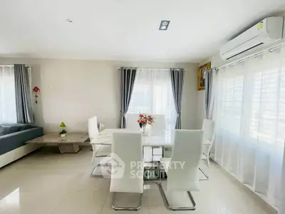 Spacious modern living room with elegant dining area and natural light
