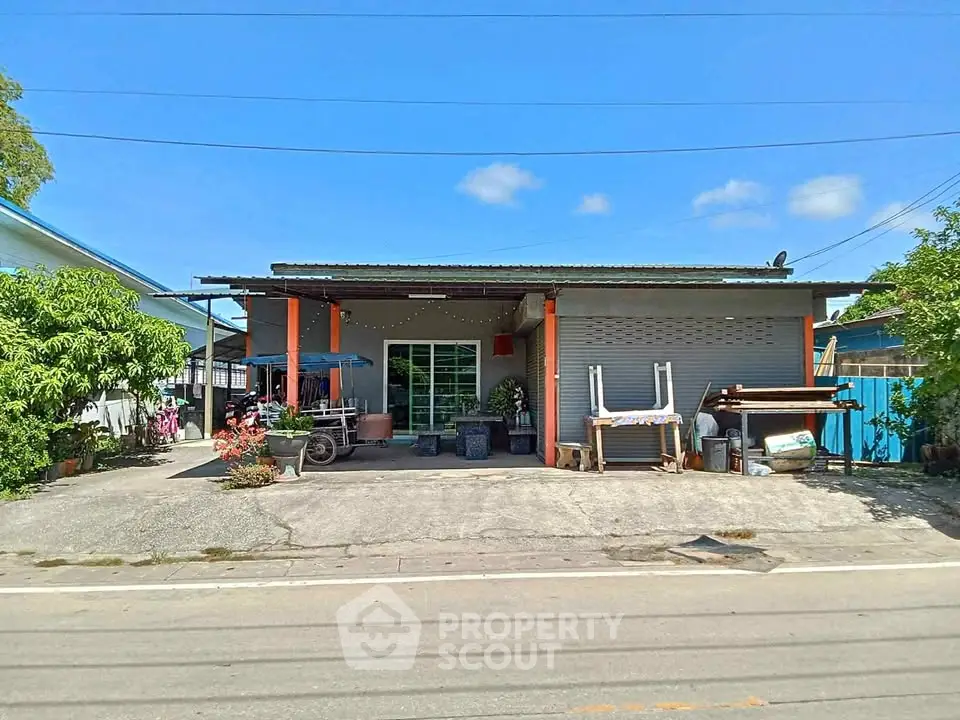 Charming single-story home with spacious driveway and lush greenery, perfect for serene living.