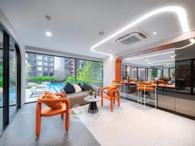 Modern living room with pool view and stylish orange chairs