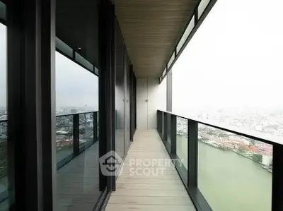Stunning high-rise balcony with panoramic city and river views, perfect for urban living.