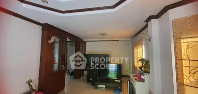 Spacious living room with elegant wooden accents and modern entertainment setup.