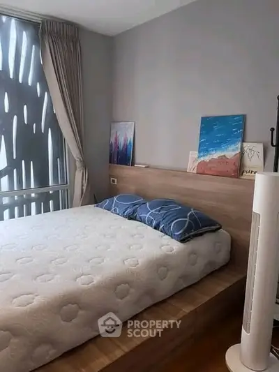 Modern bedroom with stylish decor and large window for natural light