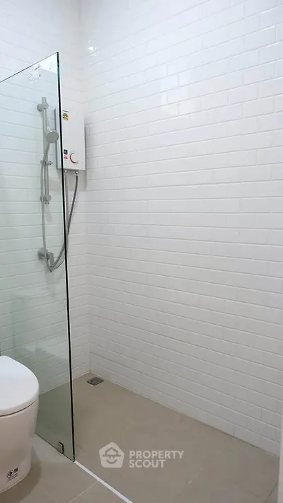 Modern bathroom with glass shower and white subway tiles