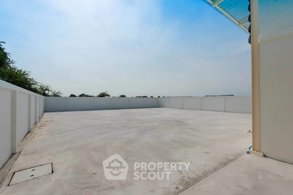 Spacious rooftop area with clear sky view, perfect for outdoor activities and gatherings.