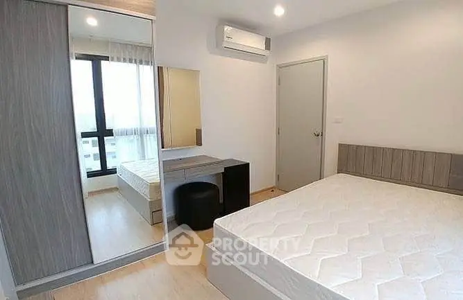 Modern bedroom with large window and stylish furniture